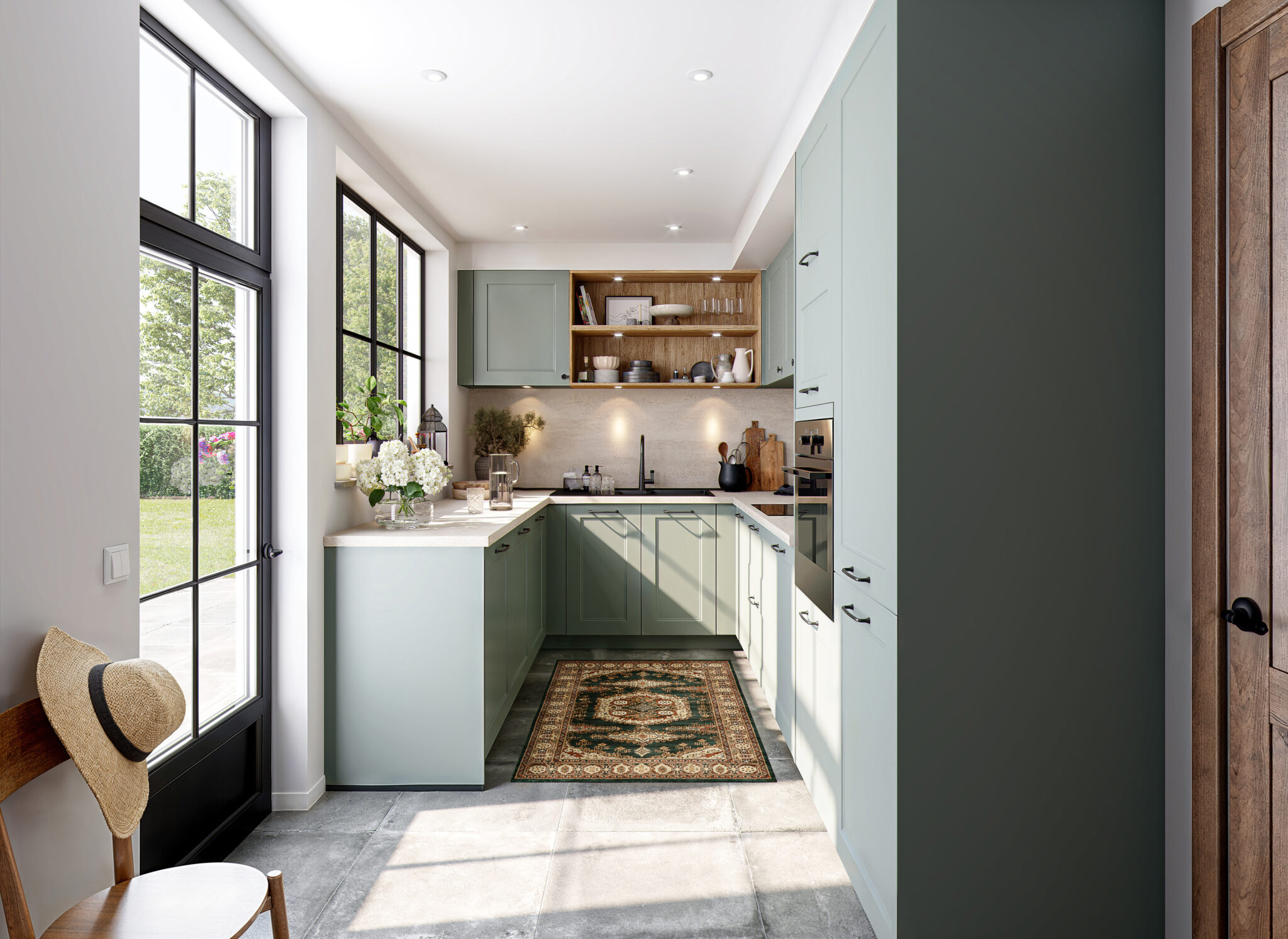 Cuisine moderne en L avec armoires vert menthe, plan de travail en bois clair, grandes fenêtres et tapis décoratif sur sol en carrelage gris.